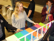 Chloe of the Trolls demonstrates their illuminating Rainbow Bridge prototype