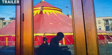 Silhouette of ffilmmaker in fron of red circus tent