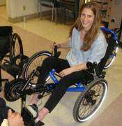 Rachael transfers into a recreational tricycle at the VA